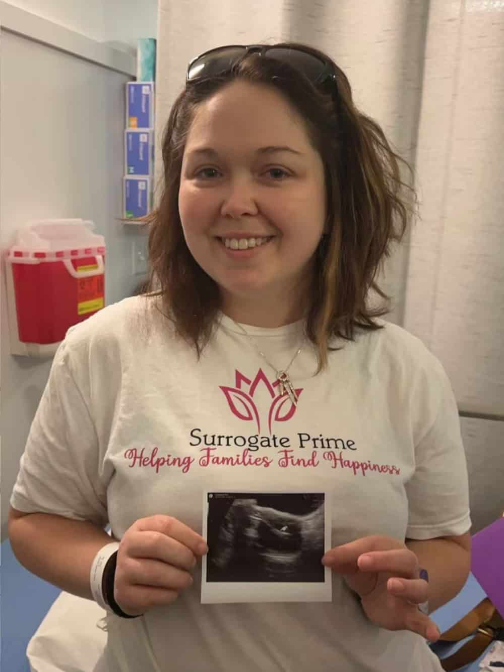 Surrogate mother in Houston capturing a heartfelt moment during her pregnancy.